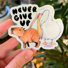 Load image into Gallery viewer, Never Give Up Capybara Pelican Holographic Glitter Vinyl Die Cut Durable Sticker