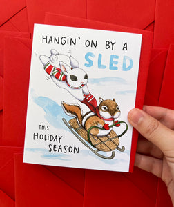 Hanging On By A Sled Winter Sledding Holiday Card